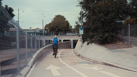 Woman riding bike on pathway