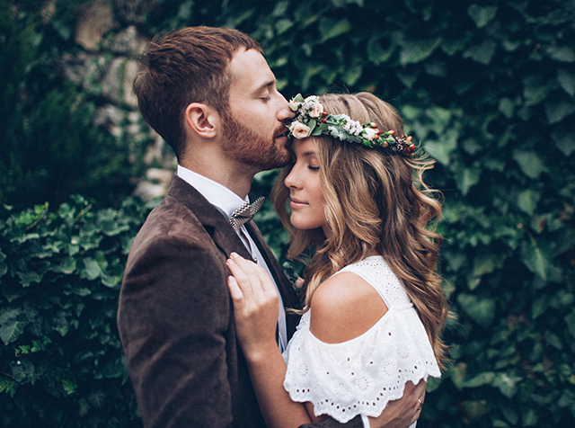 Married couple in front of greenery