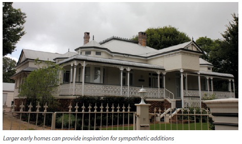 A large, early heritage house with a wrap-around verandah